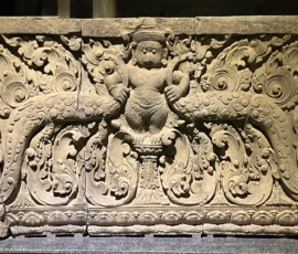 Lintel
Bakong Temple, Siem Reap Province
Preah Ko Style, Late 9th Century
Sandstone
In the center of the lintel depicts standing Garuda, the mount of Vishnu, both hands are holding the foliage branch.