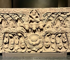 Lintel
Unknown Provenance
Angkorian Period, Baphuen Style
11th Century
Sandstone
Indra, the regent of the East, rides on the three-headed elephant Airavata who rose out of the churning of the ocean of milk.